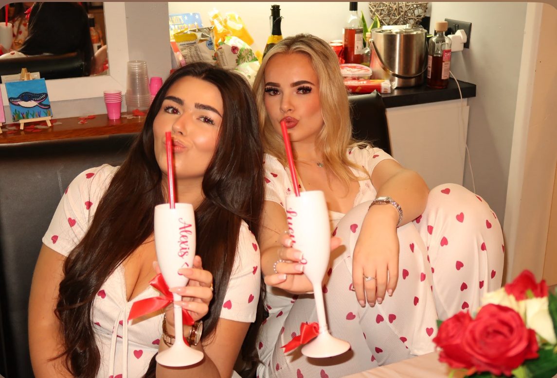 Alexis and Lucy toasting with personalised glasses